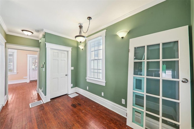 foyer entrance with dark hardwood / wood-style floors and ornamental molding