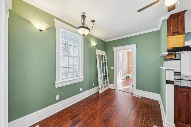 unfurnished dining area featuring dark hardwood / wood-style floors, a wealth of natural light, and crown molding