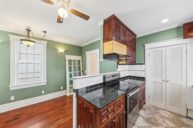 kitchen with backsplash, crown molding, electric range, ceiling fan, and range hood