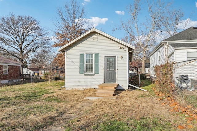 back of property with a lawn