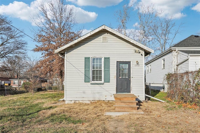 back of house with a yard