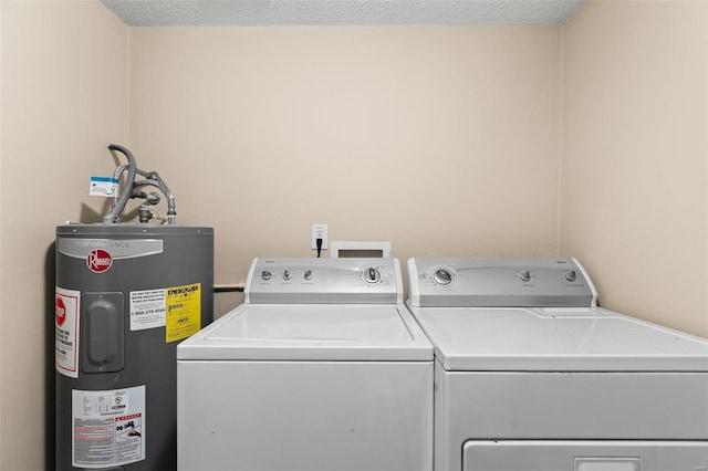 washroom with separate washer and dryer, water heater, and a textured ceiling