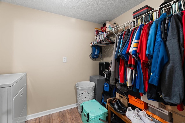 walk in closet with hardwood / wood-style floors and washer / clothes dryer