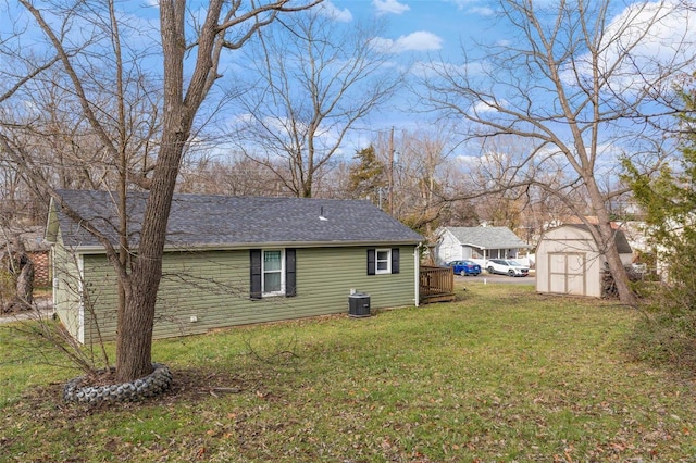 view of side of home featuring a yard, a shed, and central air condition unit