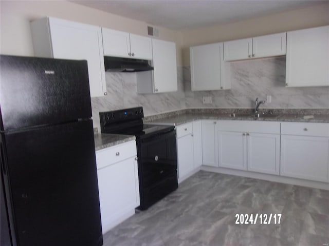 kitchen with light stone counters, sink, white cabinets, and black appliances