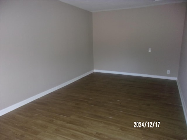 spare room with dark hardwood / wood-style floors