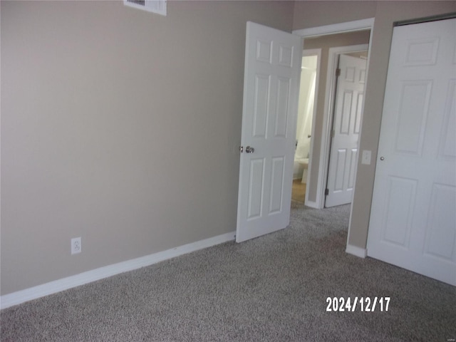 unfurnished bedroom featuring carpet flooring