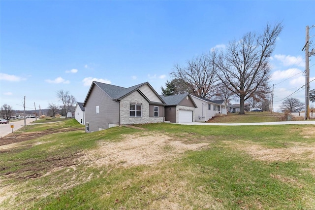 view of front of property with a garage and a front lawn