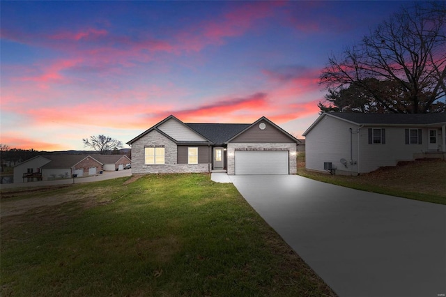 view of front of property featuring a lawn and a garage