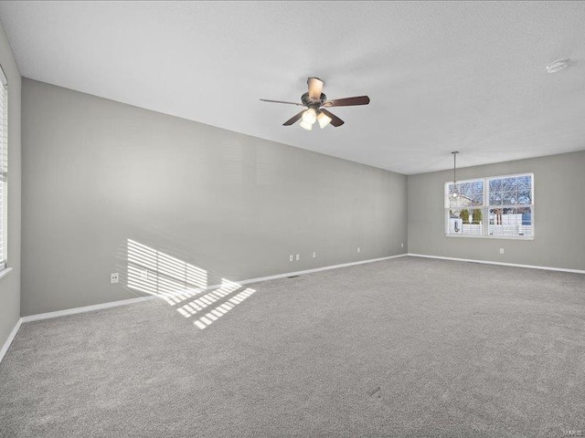 unfurnished room featuring ceiling fan and carpet floors