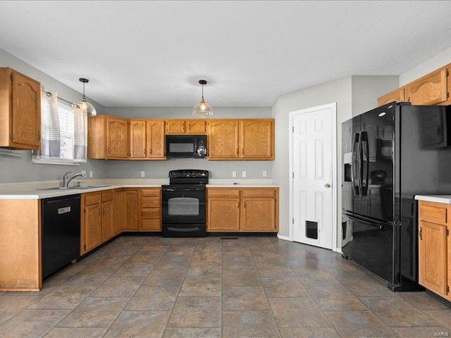 kitchen featuring black appliances, pendant lighting, and sink