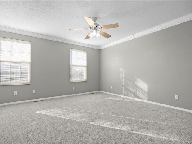 empty room with carpet, ceiling fan, ornamental molding, and a textured ceiling