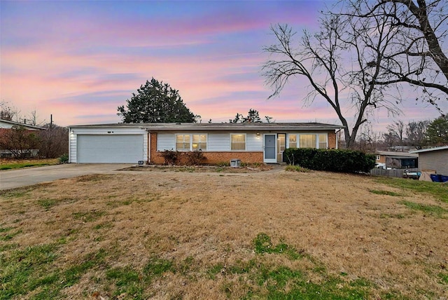 single story home featuring a yard and a garage