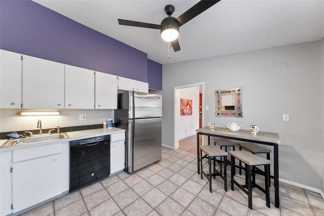 kitchen featuring ceiling fan, dishwasher, sink, stainless steel fridge, and white cabinets