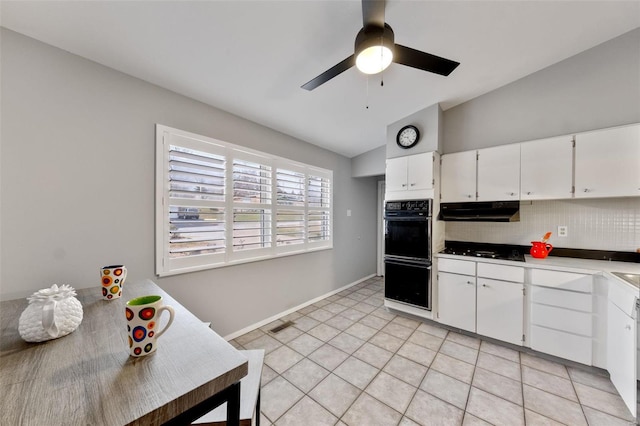 kitchen with white cabinets, vaulted ceiling, decorative backsplash, gas stovetop, and light tile patterned floors