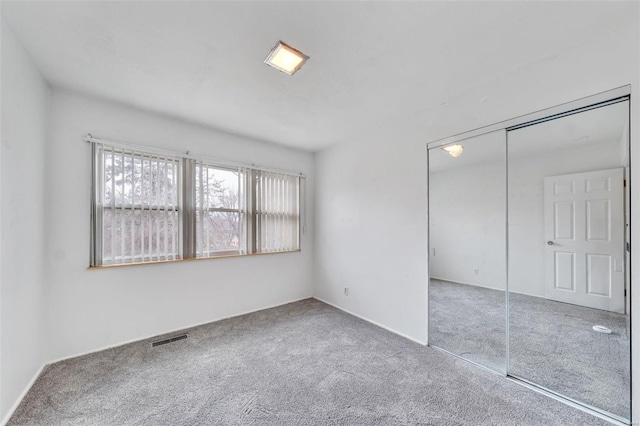 unfurnished bedroom with carpet floors and a closet