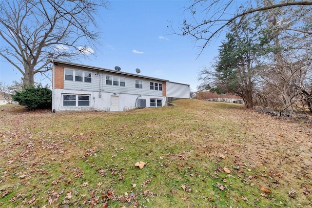 rear view of property featuring a yard