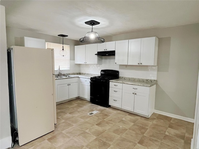 kitchen featuring pendant lighting, white fridge, black range with gas stovetop, and white cabinetry