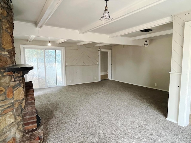 unfurnished living room with beamed ceiling and carpet floors