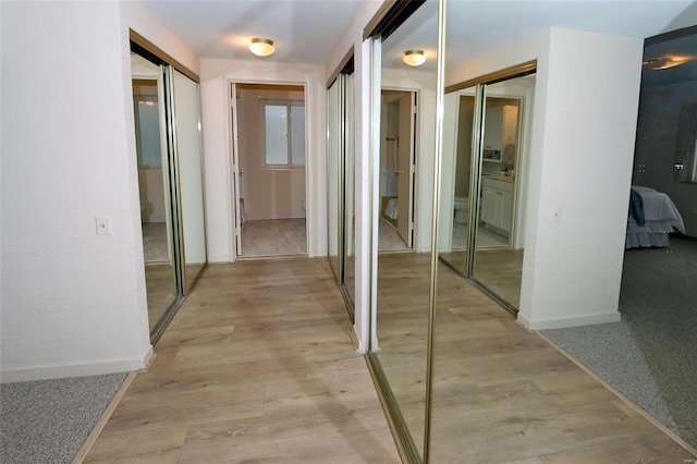 corridor with light wood-type flooring