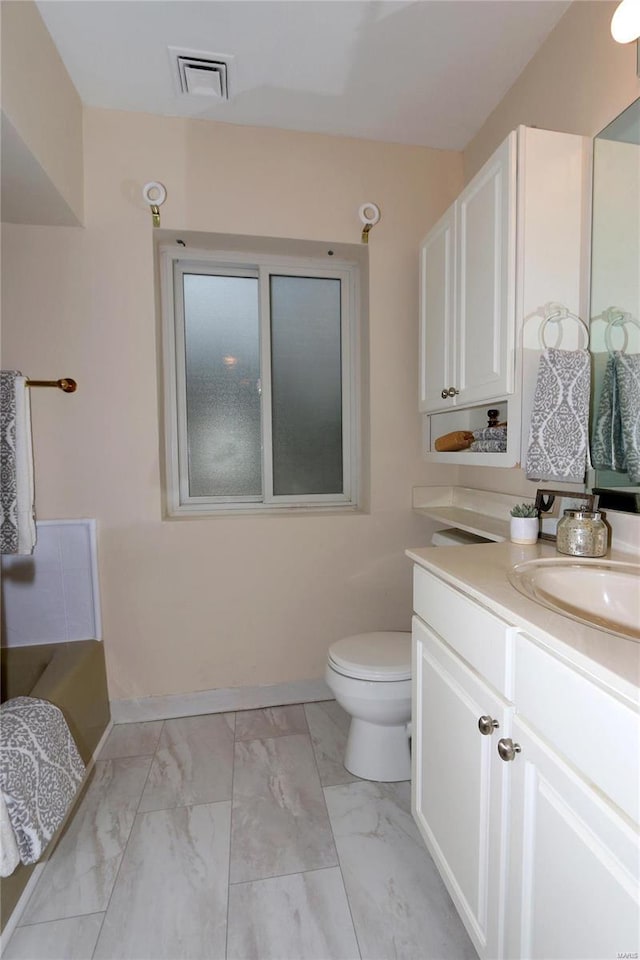 bathroom with vanity and toilet