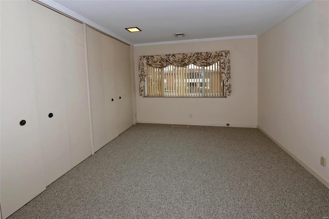 interior space featuring carpet, crown molding, and a closet