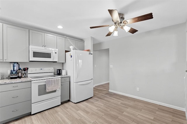 kitchen with gray cabinetry, ceiling fan, light wood-type flooring, and white appliances