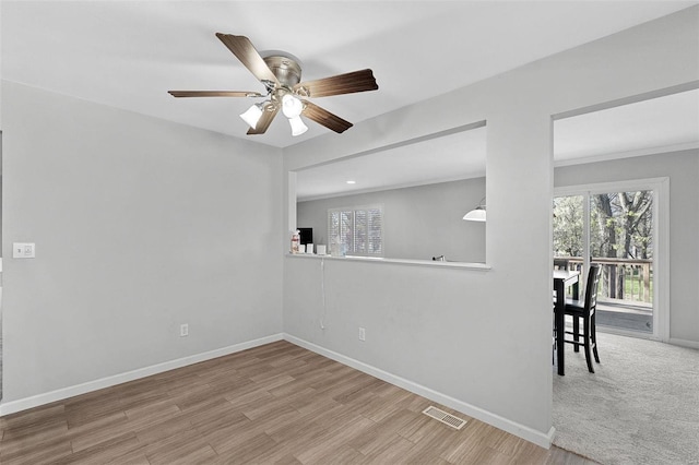 empty room featuring ceiling fan and light hardwood / wood-style flooring