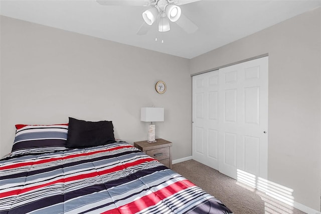 carpeted bedroom featuring ceiling fan and a closet