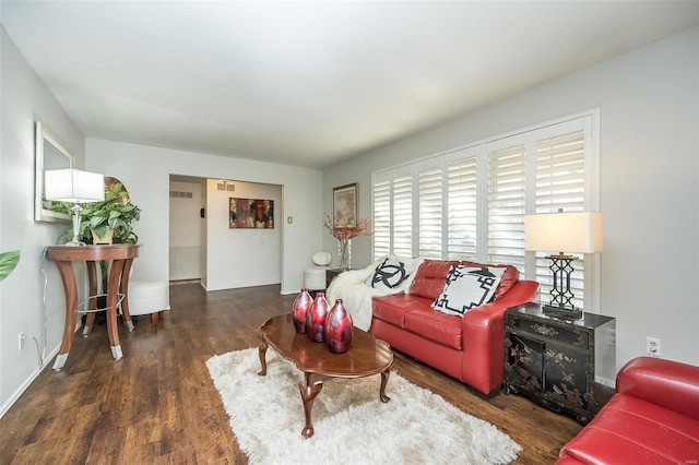 living room featuring dark wood-type flooring