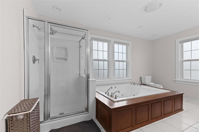 full bathroom with tile patterned floors, a tub with jets, and a shower stall