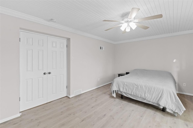 bedroom with visible vents, ornamental molding, a ceiling fan, wood finished floors, and baseboards