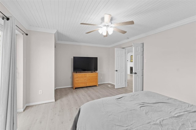 bedroom featuring baseboards, wood finished floors, and ornamental molding