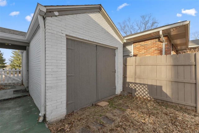 view of shed featuring fence