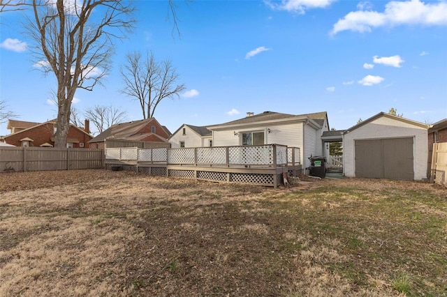 back of property featuring a wooden deck, a storage shed, a garage, an outdoor structure, and a fenced backyard