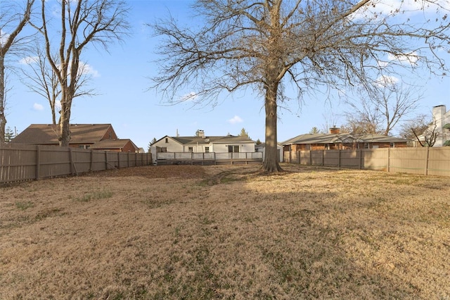 view of yard with a fenced backyard