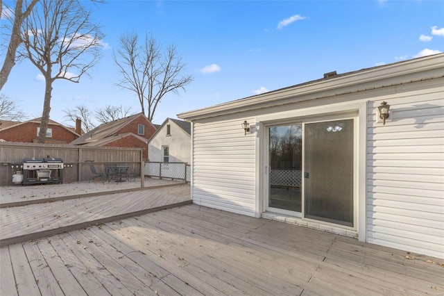 deck featuring area for grilling and fence