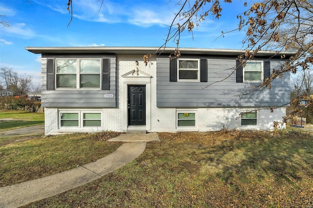 raised ranch featuring a front lawn