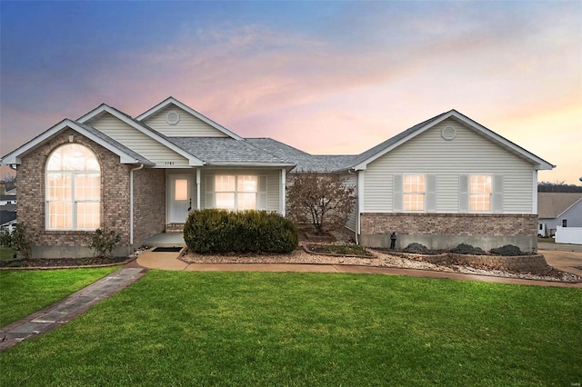 ranch-style home featuring a yard