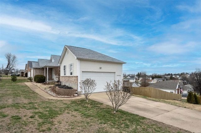 view of side of property featuring a yard and a garage