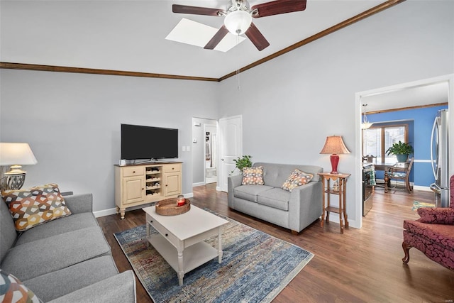 living room with baseboards, vaulted ceiling, ornamental molding, a ceiling fan, and dark wood-style flooring