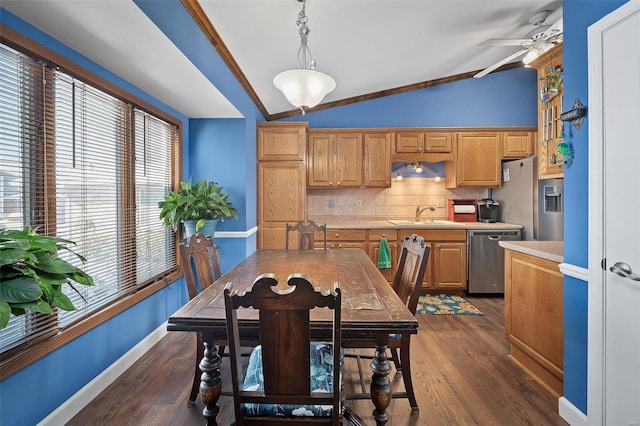 dining room featuring lofted ceiling, ornamental molding, baseboards, ceiling fan, and dark wood-style flooring