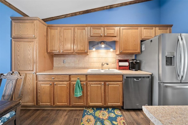 kitchen featuring a sink, backsplash, dark wood-style floors, stainless steel appliances, and light countertops