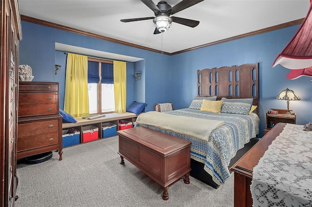 carpeted bedroom featuring ceiling fan and ornamental molding