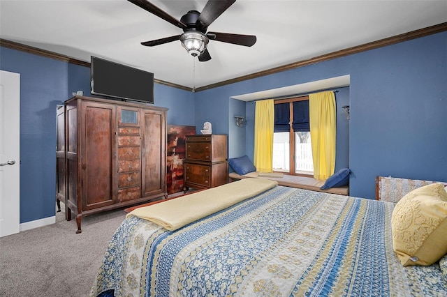 carpeted bedroom with ceiling fan, baseboards, and ornamental molding