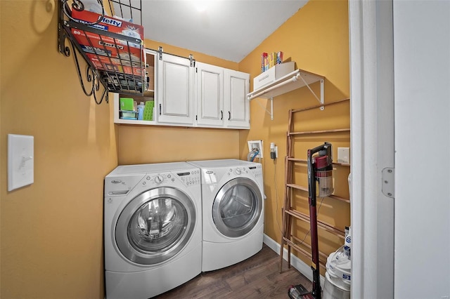 washroom with cabinet space, dark wood-style flooring, and washing machine and clothes dryer