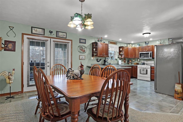 dining room with sink and a chandelier