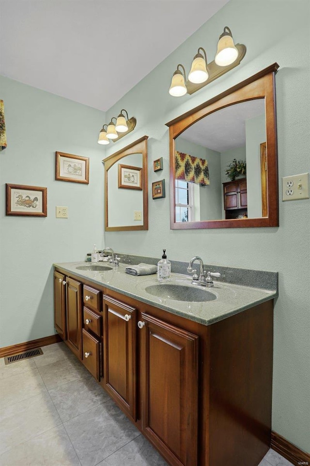 bathroom featuring tile patterned flooring and vanity