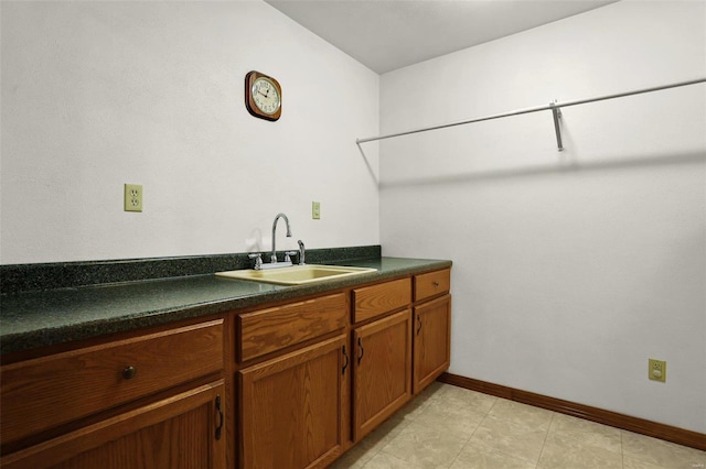 interior space with sink and light tile patterned flooring