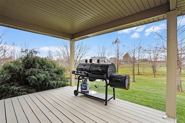 wooden terrace with a grill and a yard